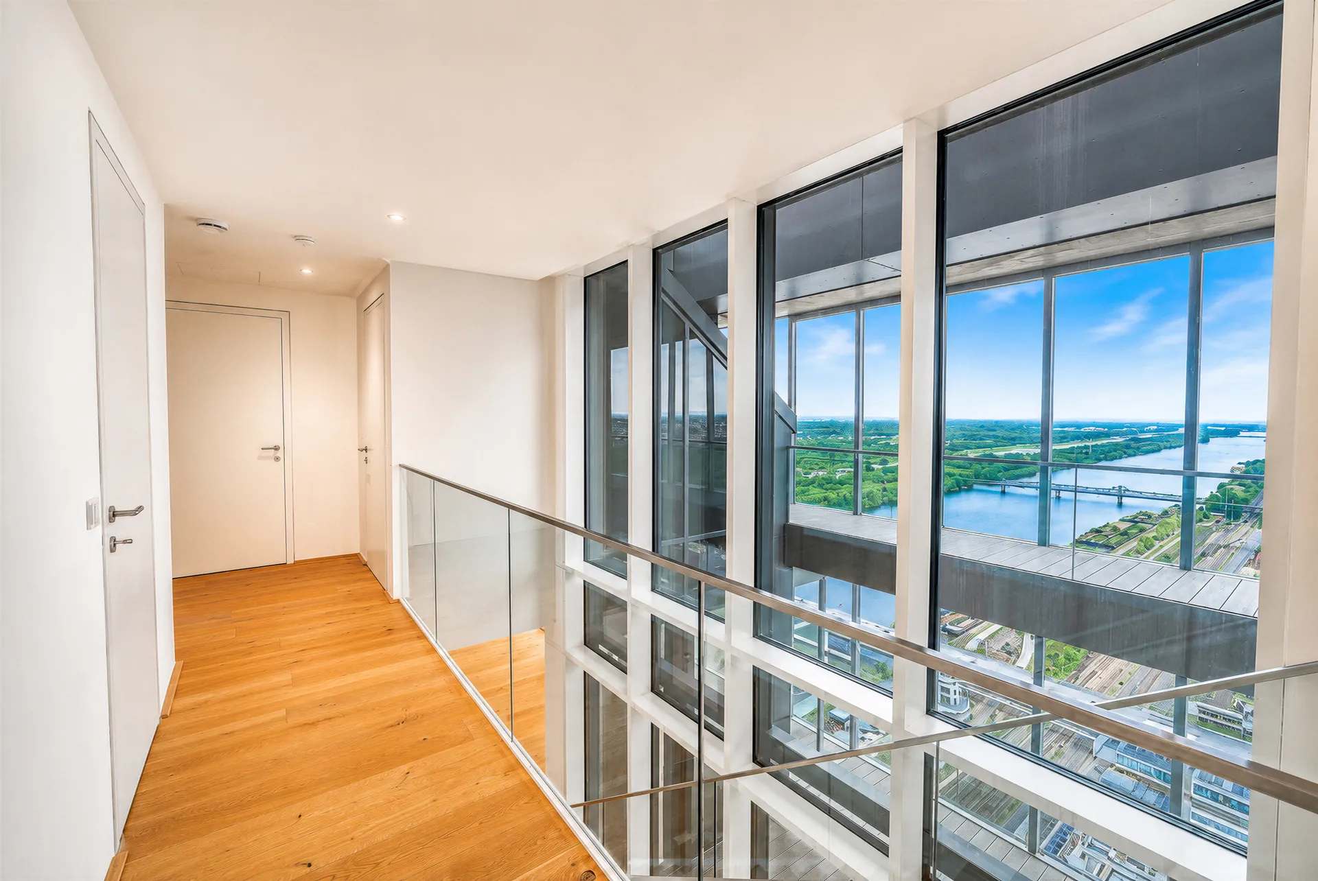 Wohnungsflur mit Glasgeländer und Ausblick